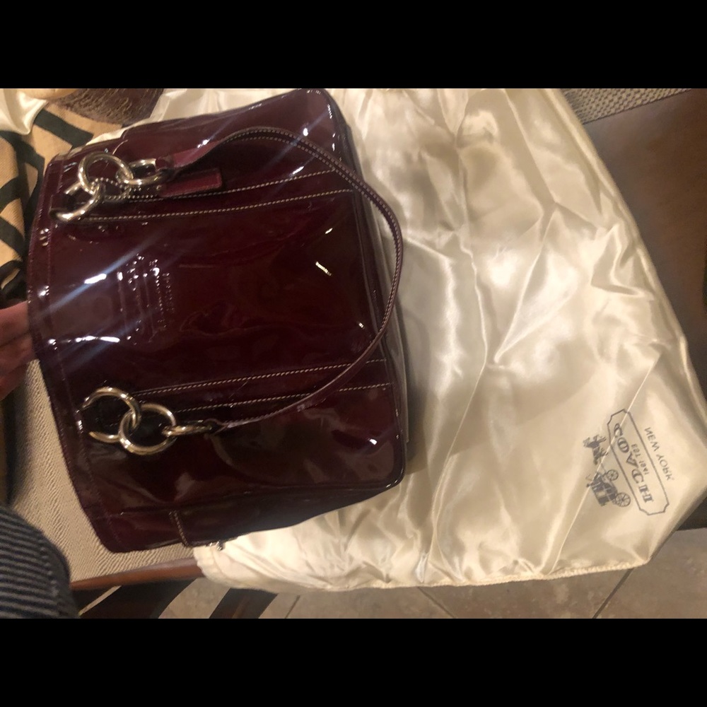 Deep red patent leather hand bag.